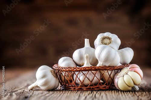 Garlic. Fresh garlic in wooden basket. Pile of garlic cloves.