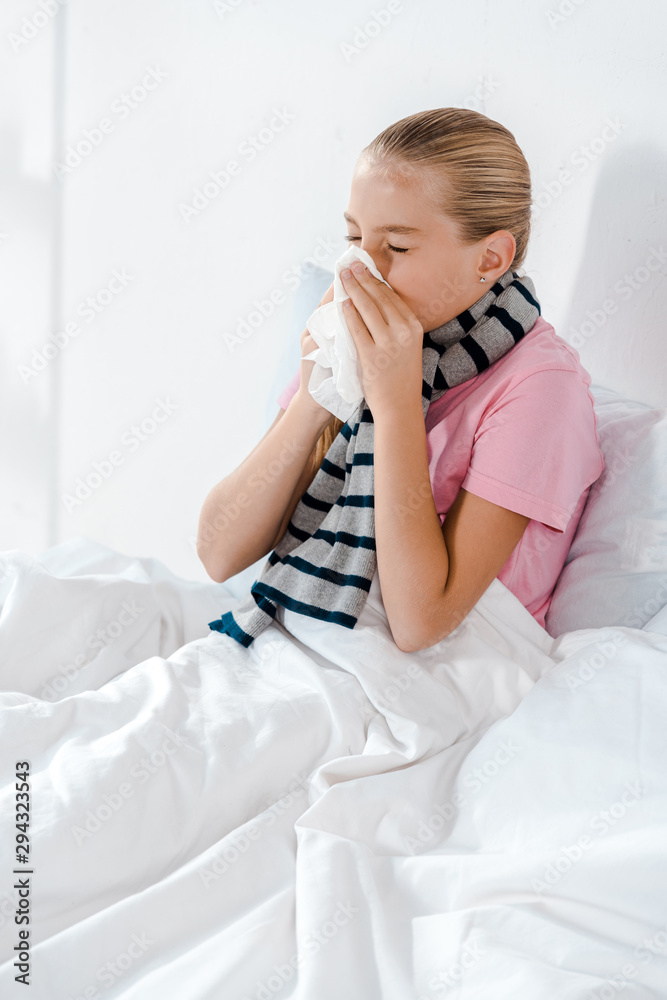 sick kid with closed eyes sneezing in tissue sick kid with closed eyes sneezing in tissue