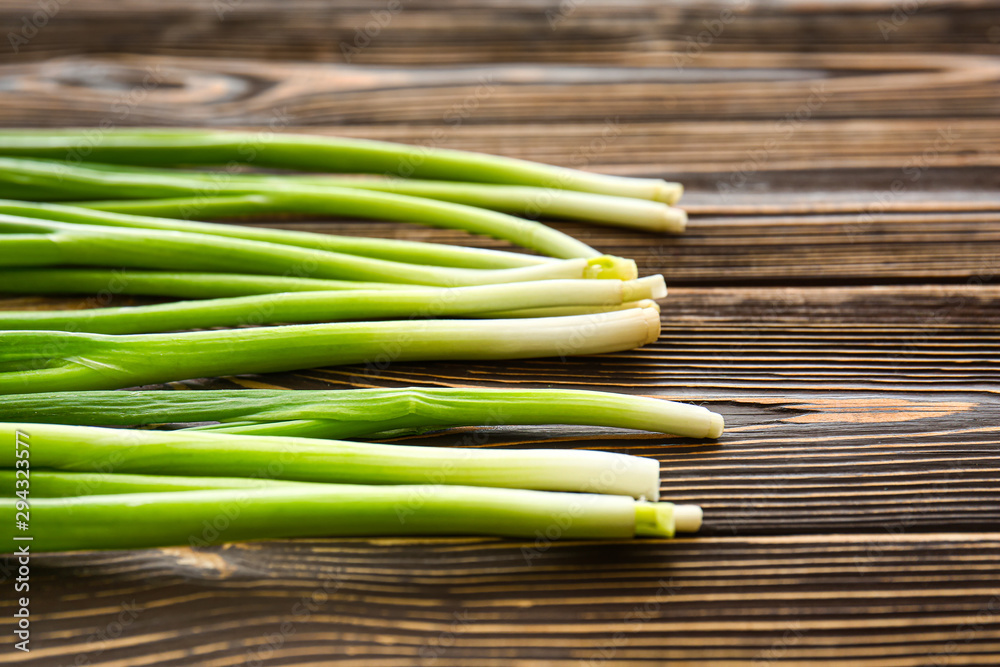 Fresh green onion on wooden background Fresh green onion on wooden background