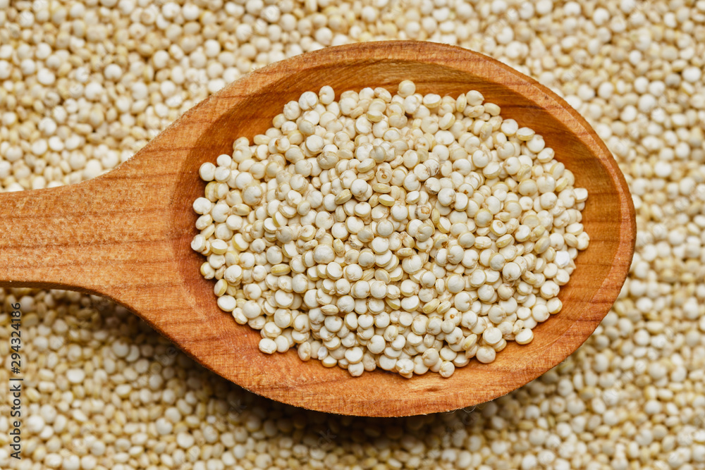 quinoa seeds in wooden spoon. quinoa seeds background quinoa seeds in wooden spoon. quinoa seeds background