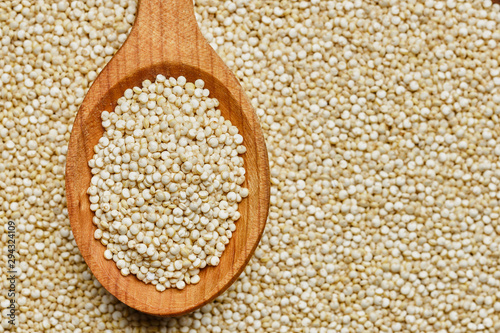 quinoa seeds in wooden spoon. quinoa seeds background