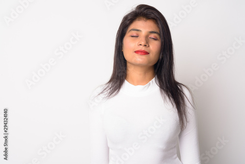 Portrait of young beautiful Persian woman relaxing with eyes closed