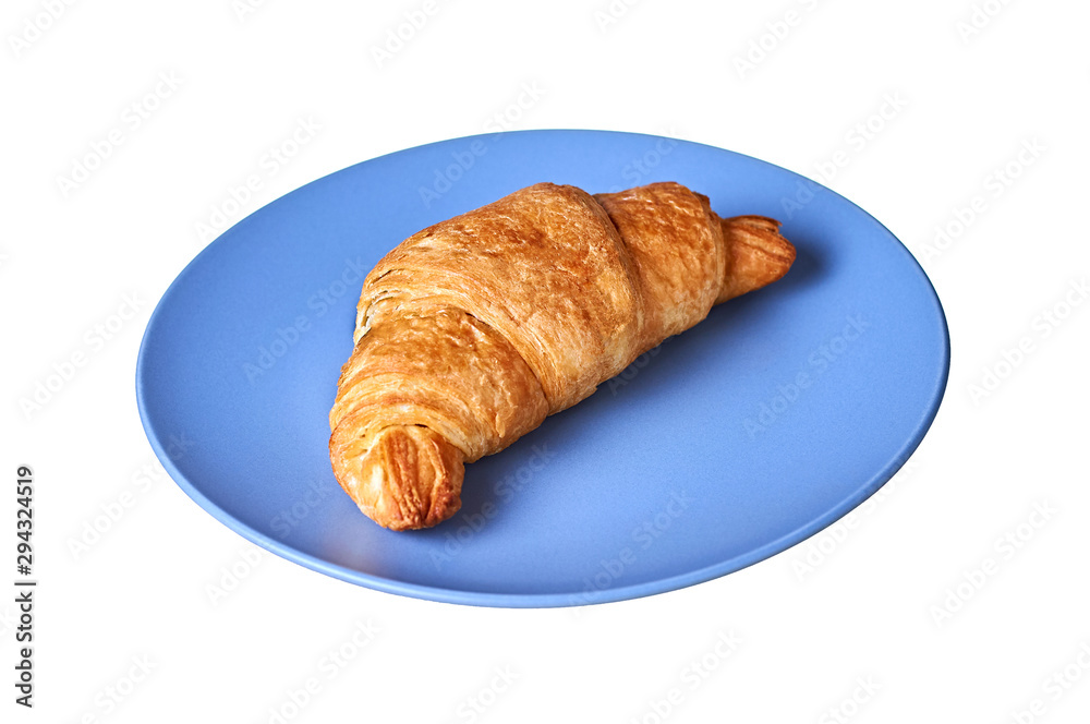 Single fresh warm crispy whole croissant filled of different tasty cream or jam lies in center of round blue ceramic plate or saucer isolated on white background without shadow. Close-up. Top view Single fresh warm crispy whole croissant filled of different tasty cream or jam lies in center of round blue ceramic plate or saucer isolated on white background without shadow. Close-up. Top view