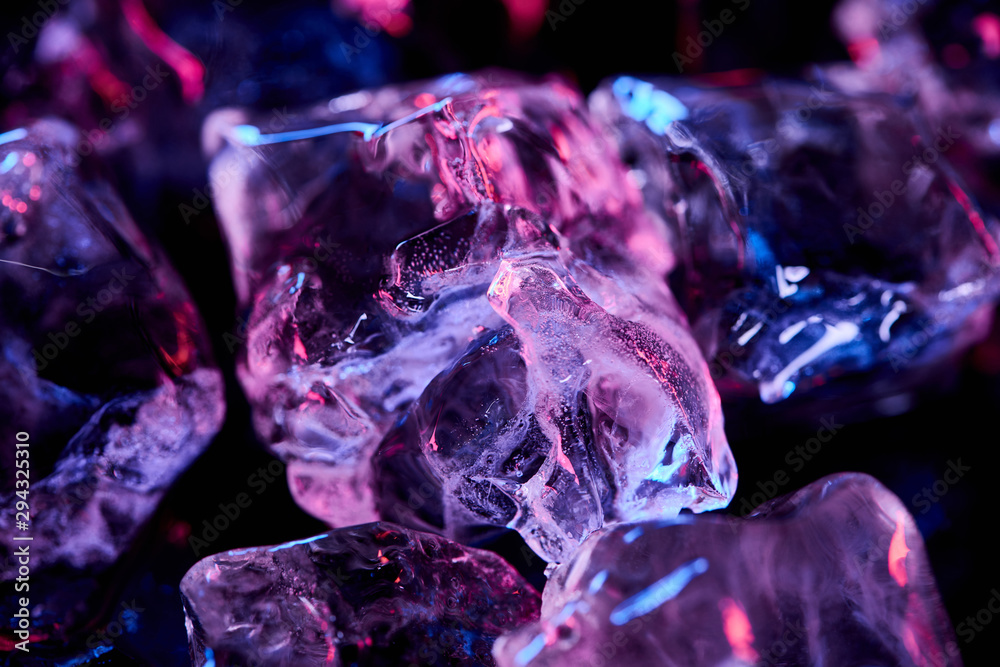 close up view of transparent ice cubes with purple lighting isolated on black close up view of transparent ice cubes with purple lighting isolated on black