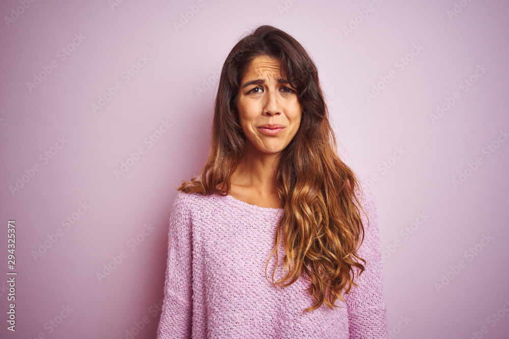 Young beautiful woman wearing sweater standing over pink isolated background depressed and worry for distress, crying angry and afraid. Sad expression. Young beautiful woman wearing sweater standing over pink isolated background depressed and worry for distress, crying angry and afraid. Sad expression.