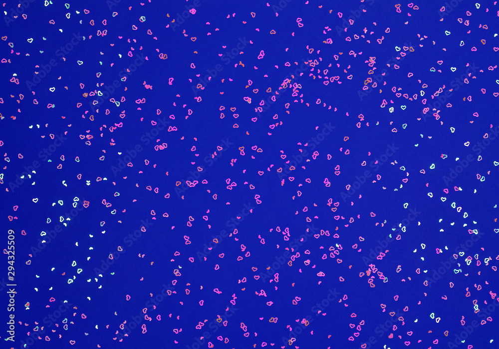 Neon pink sparkles in form of heart on blue background. Festive background for wallpaper, wrapping, backdrop, print or banner. Neon pink sparkles in form of heart on blue background. Festive background for wallpaper, wrapping, backdrop, print or banner.
