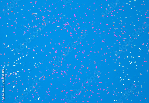 Neon pink sparkles in form of heart on blue background. Festive background for wallpaper, wrapping, backdrop, print or banner.