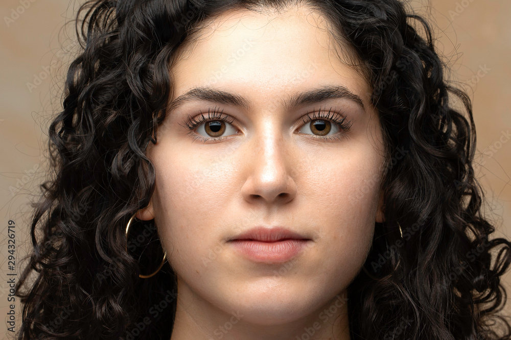 Woman with curly hair portrait in studio Woman with curly hair portrait in studio