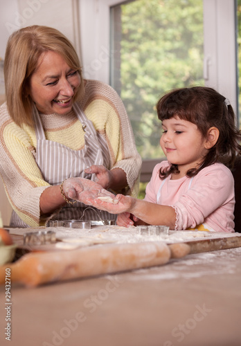 Grandmother and Granddaughter making cookies