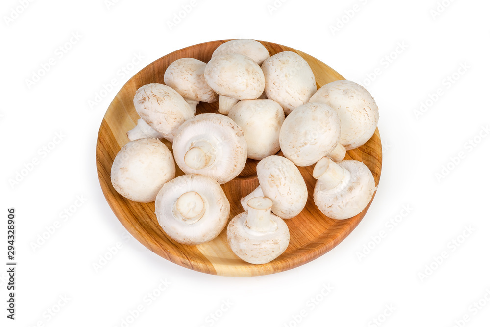 Cultivated button mushrooms on the wooden dish on white background