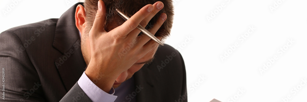 Adult male businessman holding paper sheet in hand and palm face. Wrong financial calculations led to fall in market failure on stock exchange trading error. 404 page not found concept. Adult male businessman holding paper sheet in hand and palm face. Wrong financial calculations led to fall in market failure on stock exchange trading error. 404 page not found concept.