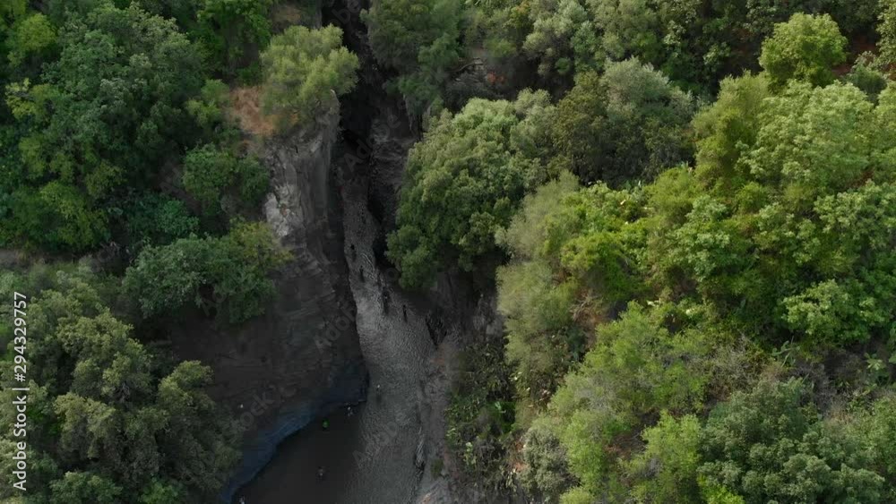 4K AERIAL: Drone descending above Alcantara Gorges, an impressive channel of lava columns eroded naturally into ravines, canyons and caves. A view over the river and its crystal water and trees 4K AERIAL: Drone descending above Alcantara Gorges, an impressive channel of lava columns eroded naturally into ravines, canyons and caves. A view over the river and its crystal water and trees