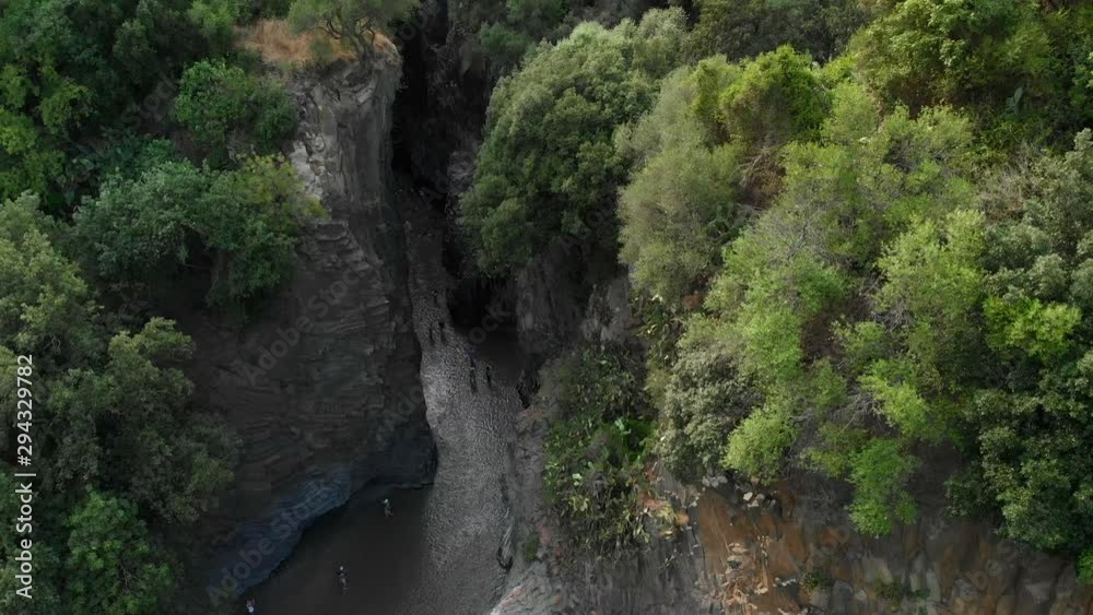 4K AERIAL: Drone descending above Alcantara Gorges, an impressive channel of lava columns eroded naturally into ravines, canyons and caves. A view over the river and its crystal water and trees 4K AERIAL: Drone descending above Alcantara Gorges, an impressive channel of lava columns eroded naturally into ravines, canyons and caves. A view over the river and its crystal water and trees