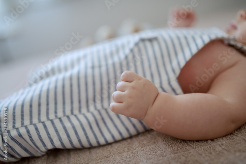 Close up of tiny baby hand. Baby lying in bed. Selective focus on hand. © dusanpetkovic1