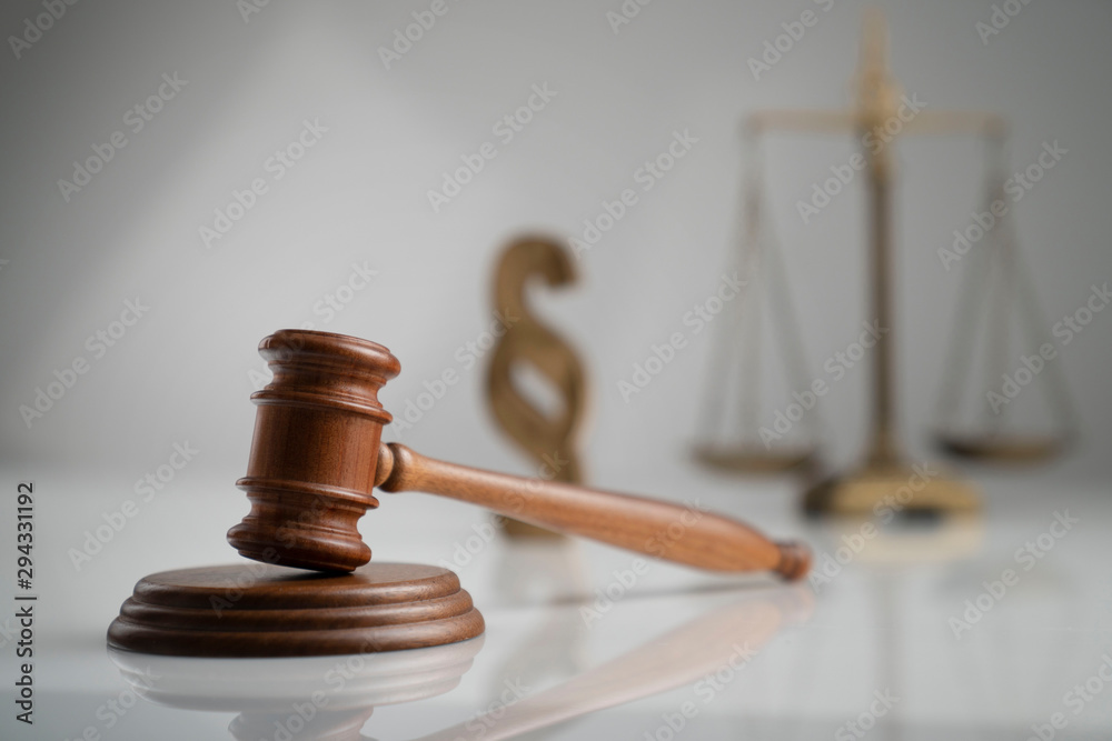 Judge antique gavel and scale - law and justice symbols on white table and background. Judge antique gavel and scale - law and justice symbols on white table and background.