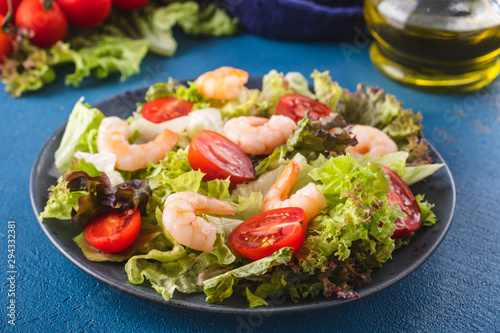 Delicious seafood salad with shrimps and fresh vegetable salad. Healthy and diet food.