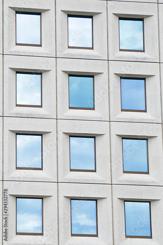 Several windows  with the sky reflected  in a modern building