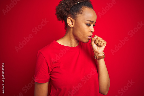 Young beautiful african american woman with afro hair over isolated red background feeling unwell and coughing as symptom for cold or bronchitis. Healthcare concept.