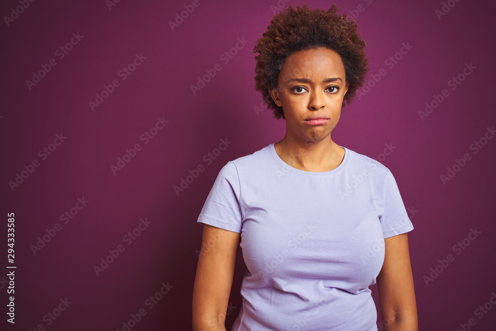 Young beautiful african american woman with afro hair over isolated purple background depressed and worry for distress, crying angry and afraid. Sad expression. Young beautiful african american woman with afro hair over isolated purple background depressed and worry for distress, crying angry and afraid. Sad expression.