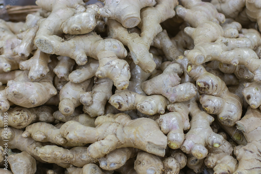 Ginger rhizome close-up background. Fresh natural ginger root on a supermarket Ginger rhizome close-up background. Fresh natural ginger root on a supermarket