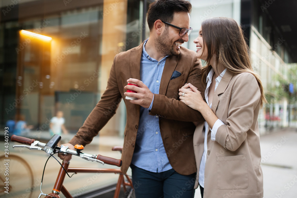 Naklejka premium Happy business colleagues talking and walking in the city outdoor