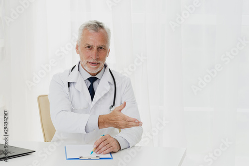 Doctor showing patient where to sit