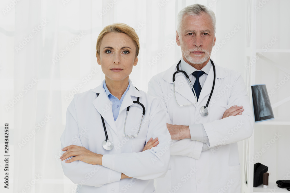 Doctors with crossed hands looking at camera Doctors with crossed hands looking at camera