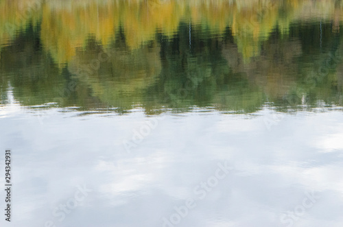 Autumn, reflection in the water autumn forest, blue ahd green background