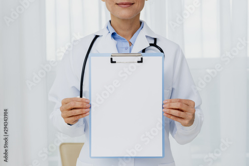 Doctor holding clipboard mock-up