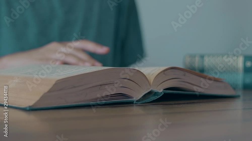 Woman reading book on the table