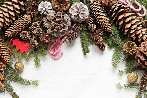 Christmas festive background with fir branches, cones and traditional decoration. Overhead view, copy space photo