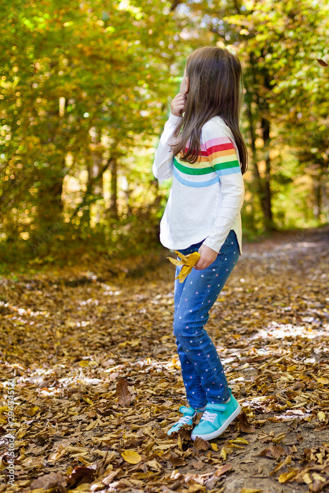 Outdoor recreation and awesome adventures with kids in fall . A little baby girl walks through the autumn forest in sunny day and collects yellow leaves. Exploring nature, travel, family vacation. Outdoor recreation and awesome adventures with kids in fall . A little baby girl walks through the autumn forest in sunny day and collects yellow leaves. Exploring nature, travel, family vacation.
