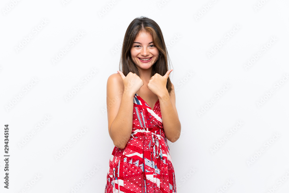 Caucasian girl in red dress over isolated white wall with thumbs up gesture and smiling Caucasian girl in red dress over isolated white wall with thumbs up gesture and smiling