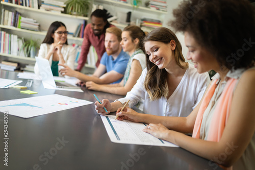 Cheerful coworkers in office during company meeting