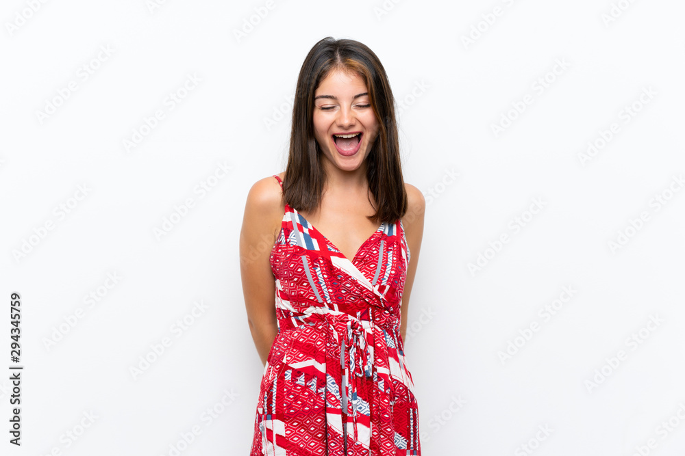 Caucasian girl in red dress over isolated white wall shouting to the front with mouth wide open Caucasian girl in red dress over isolated white wall shouting to the front with mouth wide open