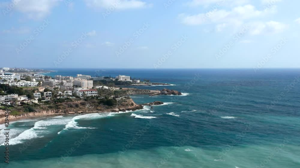 Aerial: drone flying over Potima Bay near Paphos, Cyprus. Beautiful blue sea with luxury villas and hotels at background. Aerial: drone flying over Potima Bay near Paphos, Cyprus. Beautiful blue sea with luxury villas and hotels at background.