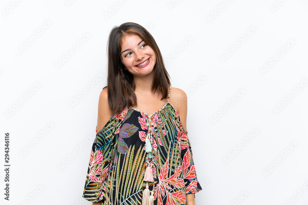 Caucasian young woman in colorful dress on isolated white background laughing and looking up Caucasian young woman in colorful dress on isolated white background laughing and looking up