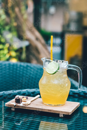 Honey and lemon iced tea with tiny dressert on the table. photo