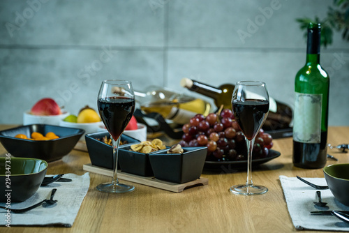 Pouring wine into glass and food background