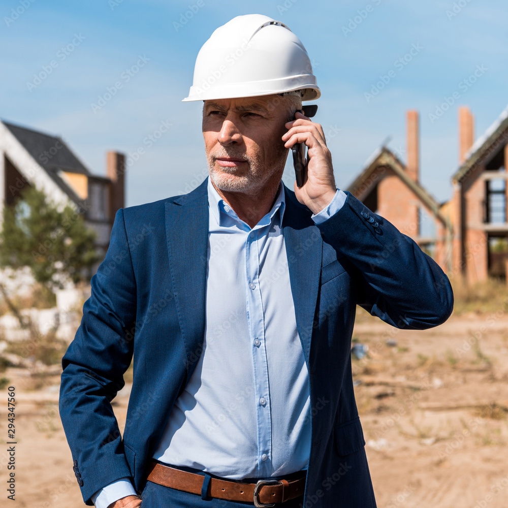 mature bearded businessman in suit talking on smartphone mature bearded businessman in suit talking on smartphone