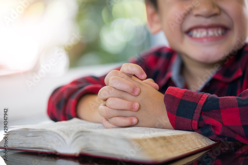 Little boy reading the Holy Bible.