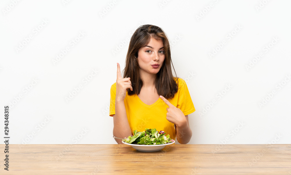 Caucasian girl with salad with surprise facial expression Caucasian girl with salad with surprise facial expression