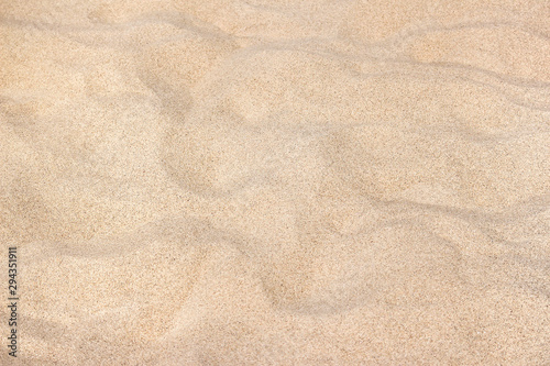 Fine beach sand in the summer sun. Light sand with barkhans.