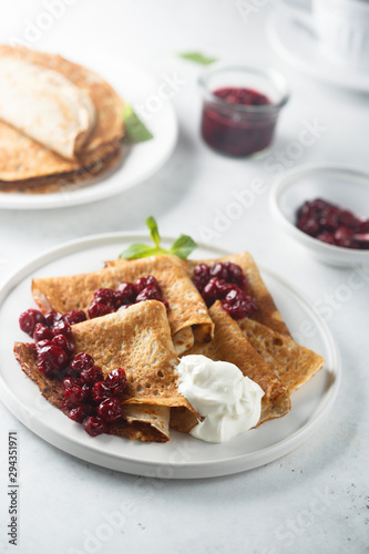Homemade crepes with cherry sauce