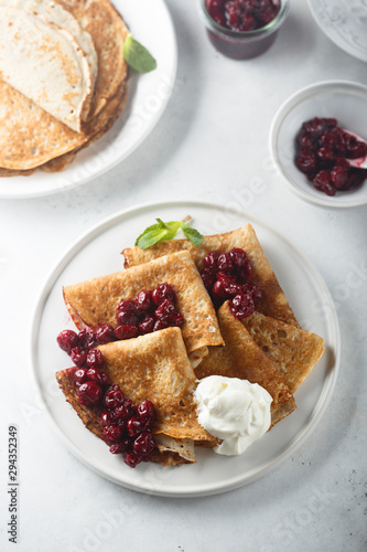Obraz na plátně Homemade crepes with cherry sauce