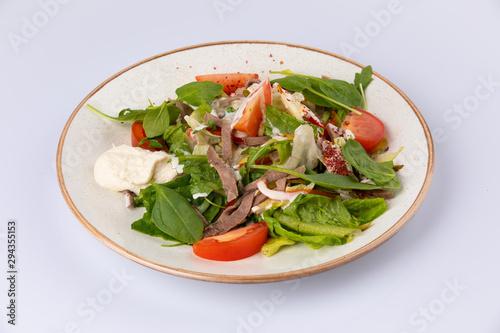 fresh salad with meat, spinach, tomato and sauce
