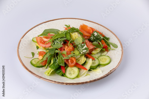Various fresh mix salad with salmon, tomato, cucumber, onion, bell pepper, healthy food and diet menu.