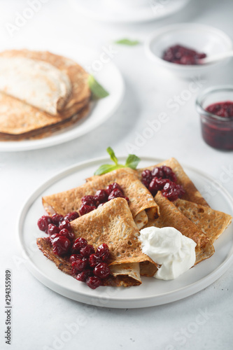 Homemade crepes with cherry sauce