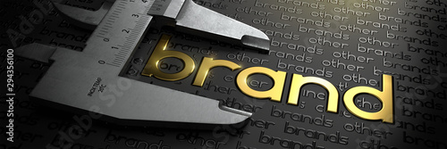 Business Concept with Golden Word BRAND on Black Background and Vernier Caliper. photo