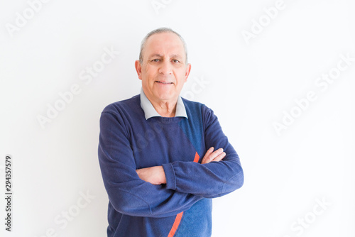 Handsome middle age senior man smiling cheerful, happy and positive leaning over white background with crossed arms